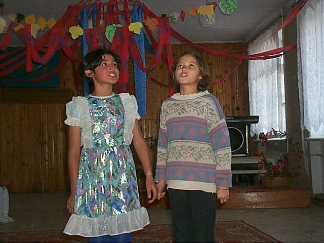 Two girls singing in orphanage